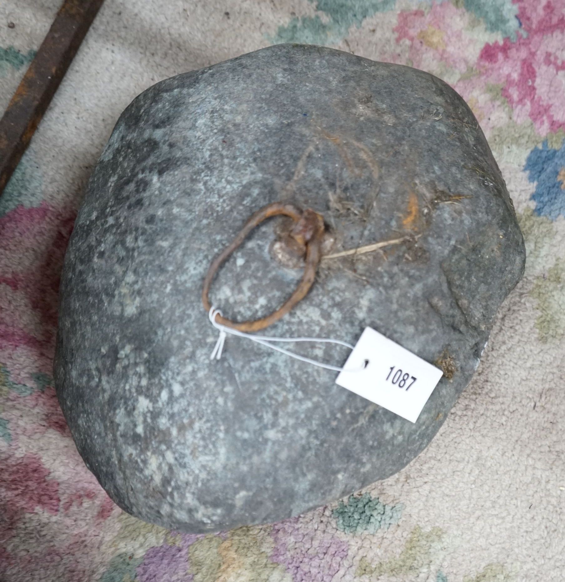 A vintage iron mounted tethering stone, width 36cm